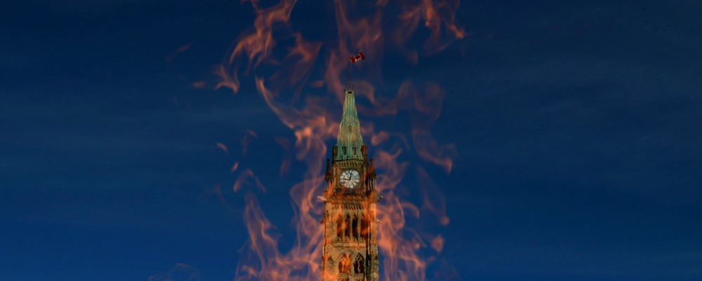 The Peace Tower is pictured through the Centennial Flame on October 23, 2013. Sean Kilpatrick/The Canadian Press. 