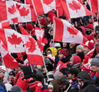 Fans cheer and wave Canadian flags before the start of the Canada-Jamaica CONCACAF World Cup soccer qualifying action in Toronto on Sunday, March 27, 2022. Frank Gunn/The Canadian Press. 