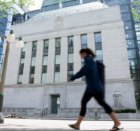 A woman walks past the Bank of Canada headquarters, Wednesday, June 1, 2022 in Ottawa. Adrian Wyld/The Canadian Press. 