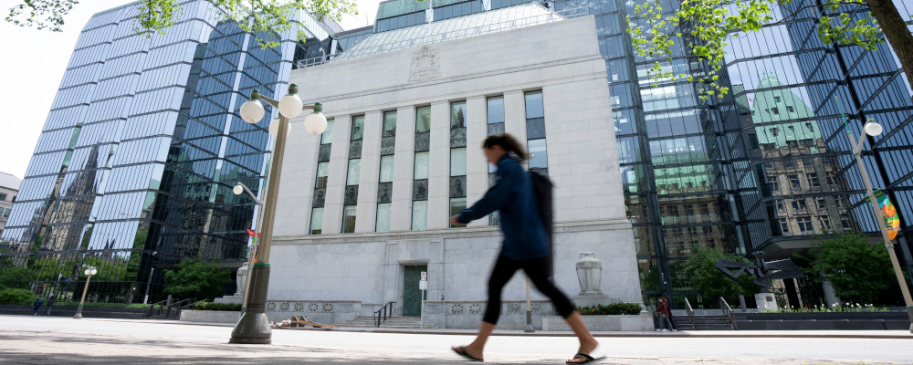 A woman walks past the Bank of Canada headquarters, Wednesday, June 1, 2022 in Ottawa. Adrian Wyld/The Canadian Press. 