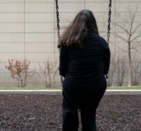 A teen girl sits for a portrait in a park near her home in Illinois on Friday, March 24, 2023. Erin Hooley/AP Photo. 