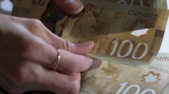 Canadian $100 bills are counted in Toronto, Feb. 2, 2016. Graeme Roy/The Canadian Press.