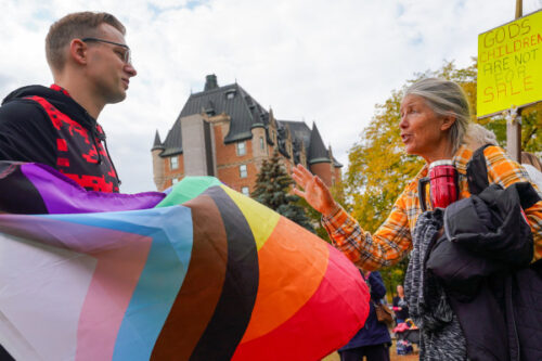 A counter-demonstrator, left, and a demonstrator, right, debate during a protest in Saskatoon, Sask., on Wednesday, September 20, 2023. Heywood Yu/The Canadian Press. 