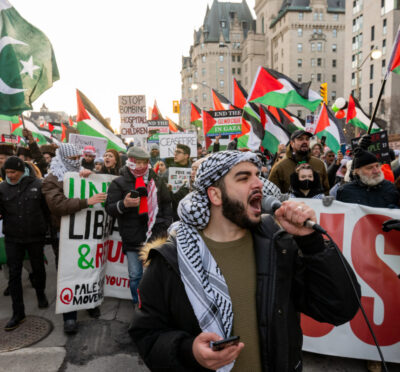 A pro-Palestinian protester leads a chant during a protest on Parliament Hill in Ottawa, on Saturday, Nov. 25, 2023. Spencer Colby/The Canadian Press. 