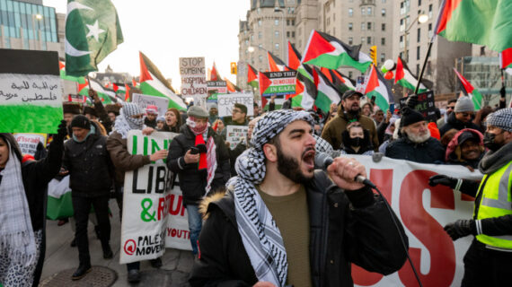A pro-Palestinian protester leads a chant during a protest on Parliament Hill in Ottawa, on Saturday, Nov. 25, 2023. Spencer Colby/The Canadian Press. 