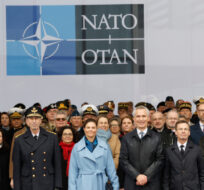NATO Secretary General Jens Stoltenberg, front center, Sweden's Prime Minister Ulf Kristersson, center right, and Sweden's Crown Princess Victoria, center left, pose with military and staff personnel after a ceremony to mark the accession of Sweden to NATO at NATO headquarters in Brussels, Monday, March 11, 2024. Geert Vanden Wijngaert/AP Photo. 