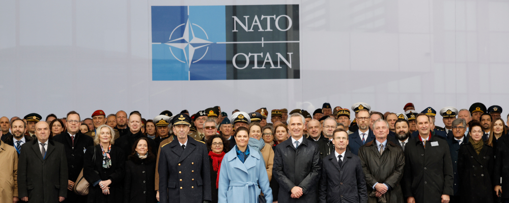 NATO Secretary General Jens Stoltenberg, front center, Sweden's Prime Minister Ulf Kristersson, center right, and Sweden's Crown Princess Victoria, center left, pose with military and staff personnel after a ceremony to mark the accession of Sweden to NATO at NATO headquarters in Brussels, Monday, March 11, 2024. Geert Vanden Wijngaert/AP Photo. 