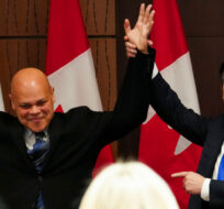 Conservative Leader Pierre Poilievre raises the hand of newly-elected Conservative member of Parliament Jamil Jivani as he introduces him at a caucus meeting on Parliament Hill in Ottawa on Wednesday, March 20, 2024. Sean Kilpatrick/The Canadian Press. 