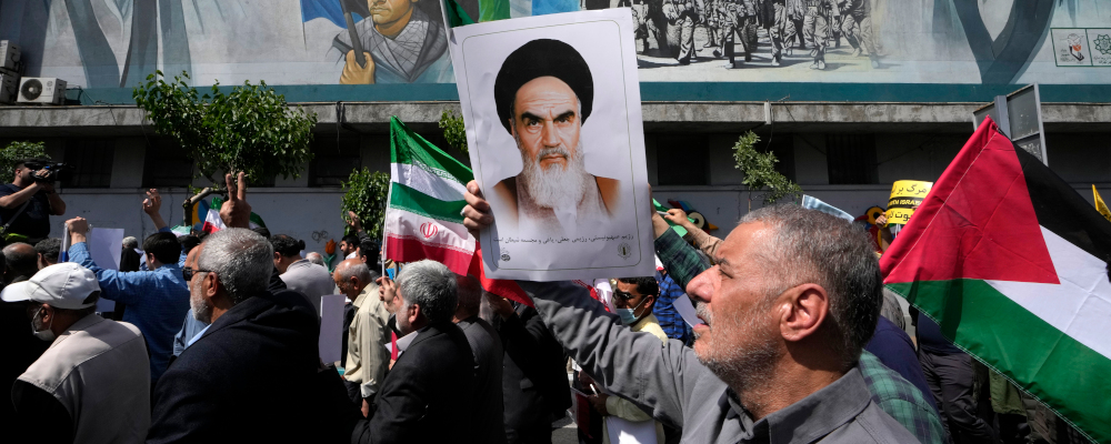 Iranian worshippers  hold a poster of Ayatollah Khomeini and Iranian and Palestinian flags in an anti-Israeli gathering after their Friday prayer in Tehran, Iran, Friday, April 19, 2024. Vahid Salemi/AP Photo.