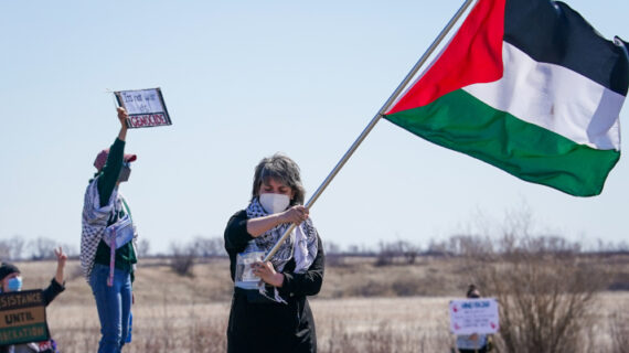 A person waves a Palestinian flag outside of Wanuskewin Heritage Park near Saskatoon, Sask., on Tuesday, April 23, 2024. Heywood Yu/The Canadian Press. 