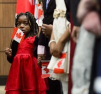 New Canadians sing the national anthem after taking the Oath of Citizenship on Parliament Hill in Ottawa on Wednesday, April 17, 2019, during a citizenship ceremony to celebrate the 37th anniversary of the Canadian Charter of Rights and Freedoms. Sean Kilpatrick/The Canadian Press. 