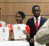 The Letang family from Haiti get their photo taken after becoming New Canadians after taking the Oath of Citizenship on Parliament Hill in Ottawa on Wednesday, April 17, 2019. Sean Kilpatrick/The Canadian Press. 