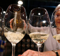 In this  Aug. 26, 2010 photo, Elizabeth Richardson pours wine for a tour group in Woodinville, Wash. Elaine Thompson/AP Photo. 