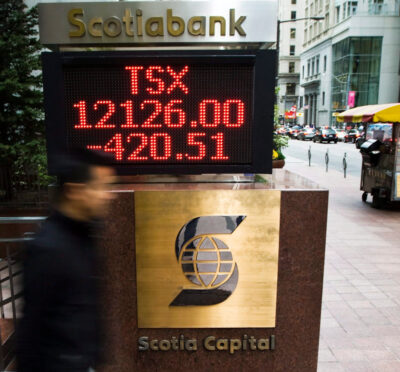 A person walks past the TSX sign in Toronto's financial district on Friday, Sept. 26, 2008 in Toronto. Nathan Denette/The Canadian Press.