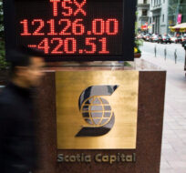 A person walks past the TSX sign in Toronto's financial district on Friday, Sept. 26, 2008 in Toronto. Nathan Denette/The Canadian Press. 