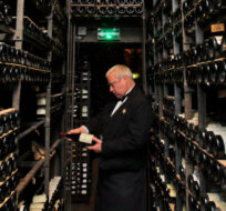 Briton David Ridgway, chief sommelier of the Tour d'Argent restaurant, holds a bottle in the cellar of La Tour d'Argent restaurant in Paris, Thursday Oct. 15, 2009. Christophe Ena/AP Photo. 